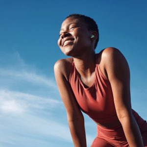 fitness-black-woman-smile-relax-running-exercise-workout-nature-outdoors-happy-african-american-female-runner-smiling-break-from-run-exercising-breathing-fresh-air Fitness, black woman and smile in relax for running, exercise or workout in the nature outdoors. Happy African American female runner smiling on a break from run, exercising and breathing fresh air.